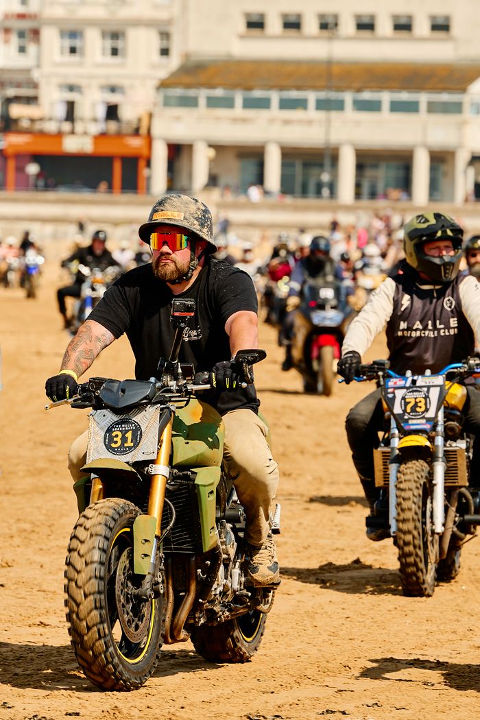 services-03 Motorcyclists participate in an exciting beach rally in Margate, England, showcasing varying riding styles.